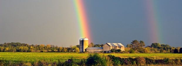 Rainbow over barn silo