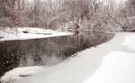Snowing on the black river