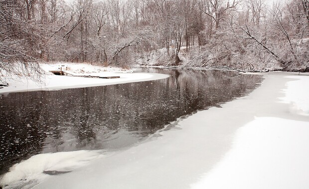 Snowing on the black river